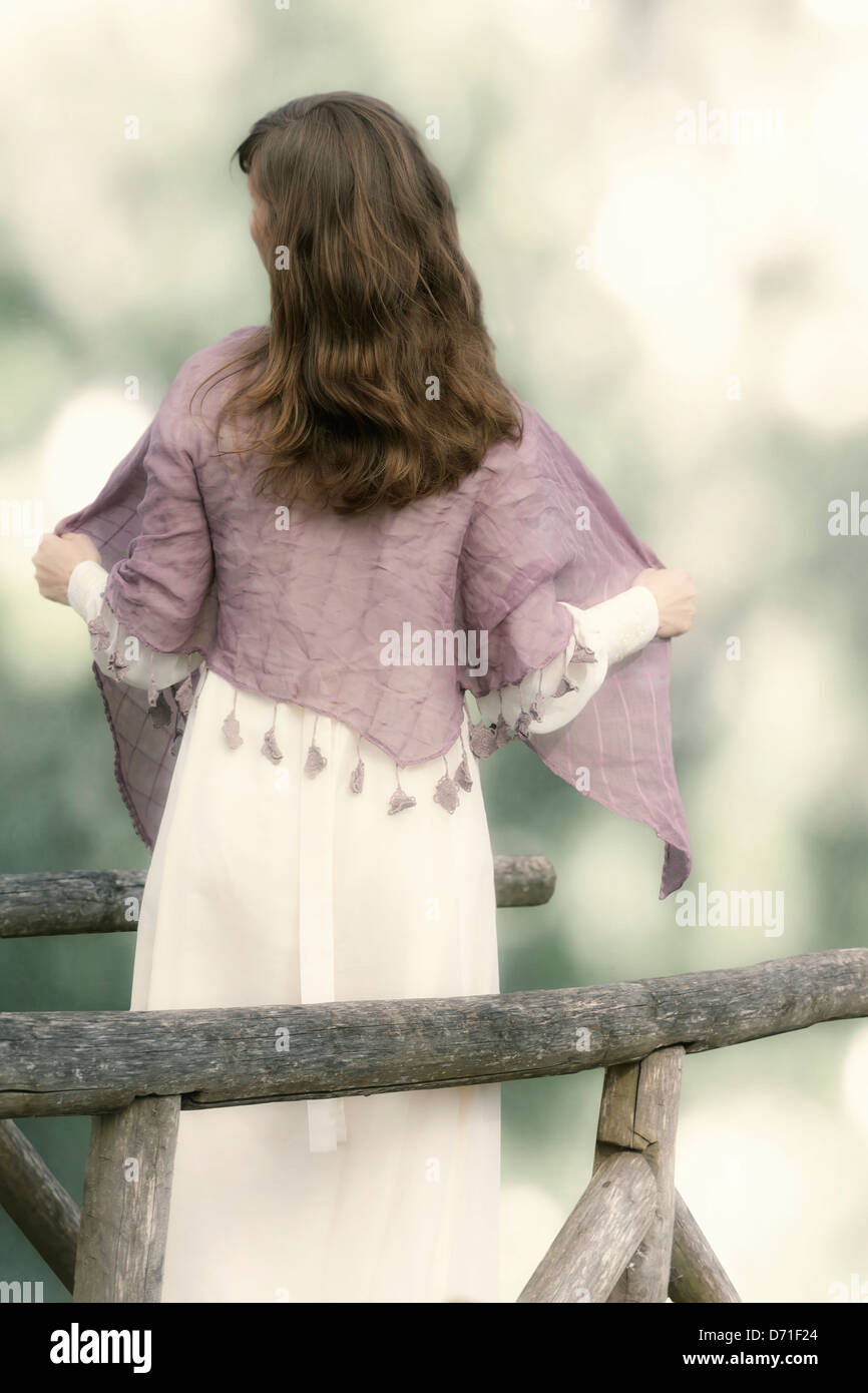 a woman on a wooden bridge Stock Photo
