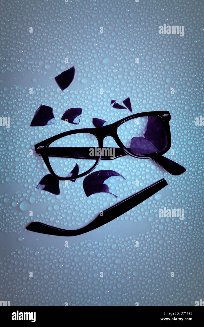 broken sunglasses on a wet table Stock Photo