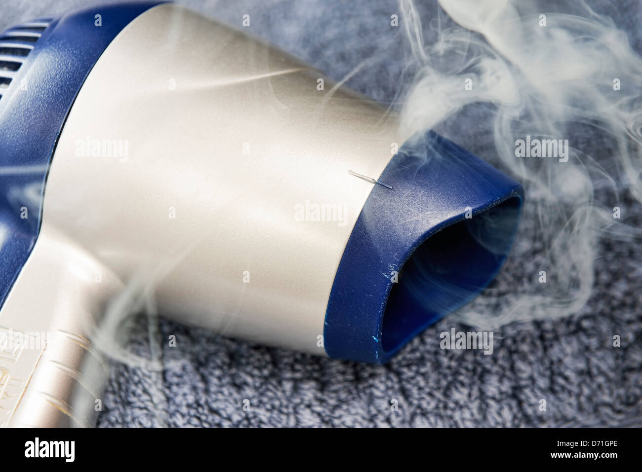 Smoke, built-in wearing parts flows out of hairdrier in electrical appliances Stock Photo