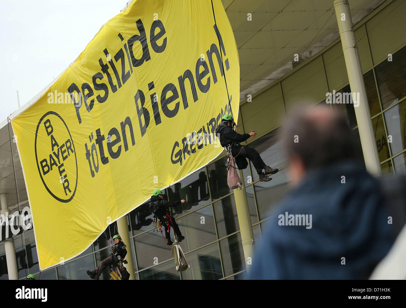 Cologne, Germany. 26th April, 2013. Greenpeace activists demonstrate in front of the site of the shareholder's meeting of pharmaceutical and chemical company Bayer in Cologne, Germany, 26 April 2013. The organisation raised awareness for pesticides and its effects on bees. Photo: OLIVER BERG/dpa/Alamy Live News Stock Photo