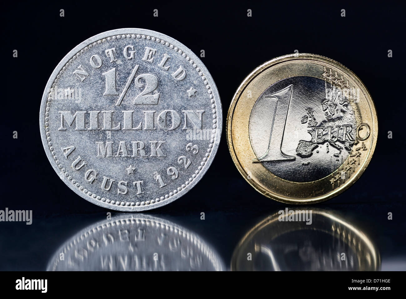 Coin with label 1/2 million euros and Euro-coin one, Symbolic photo inflation Stock Photo