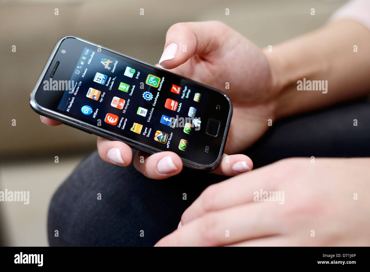 Woman holds smartphone in the hand Stock Photo