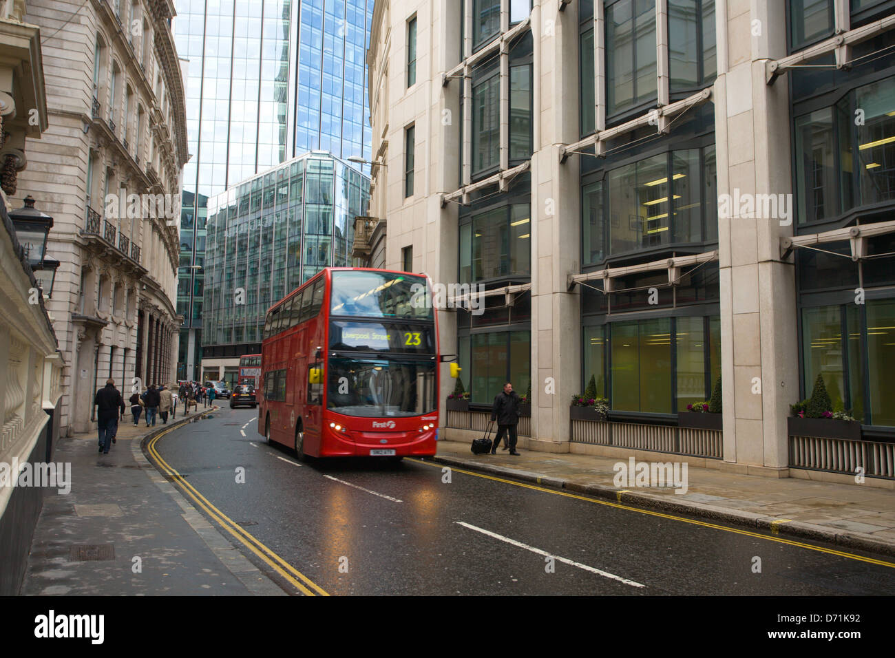 Red London bus travelling up Old Broad Street. Stock Photo
