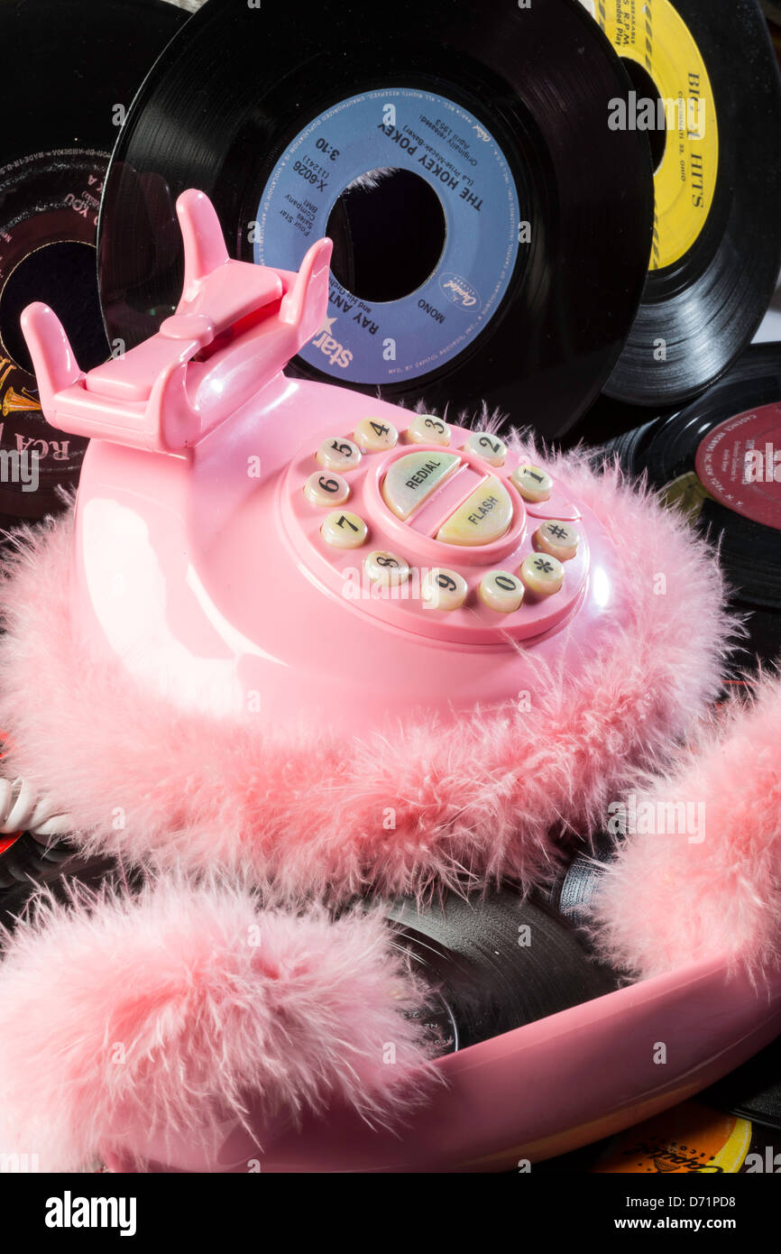 Pink Fluffy Retro Style Phone with 45rpm Records, Close Up Stock Photo