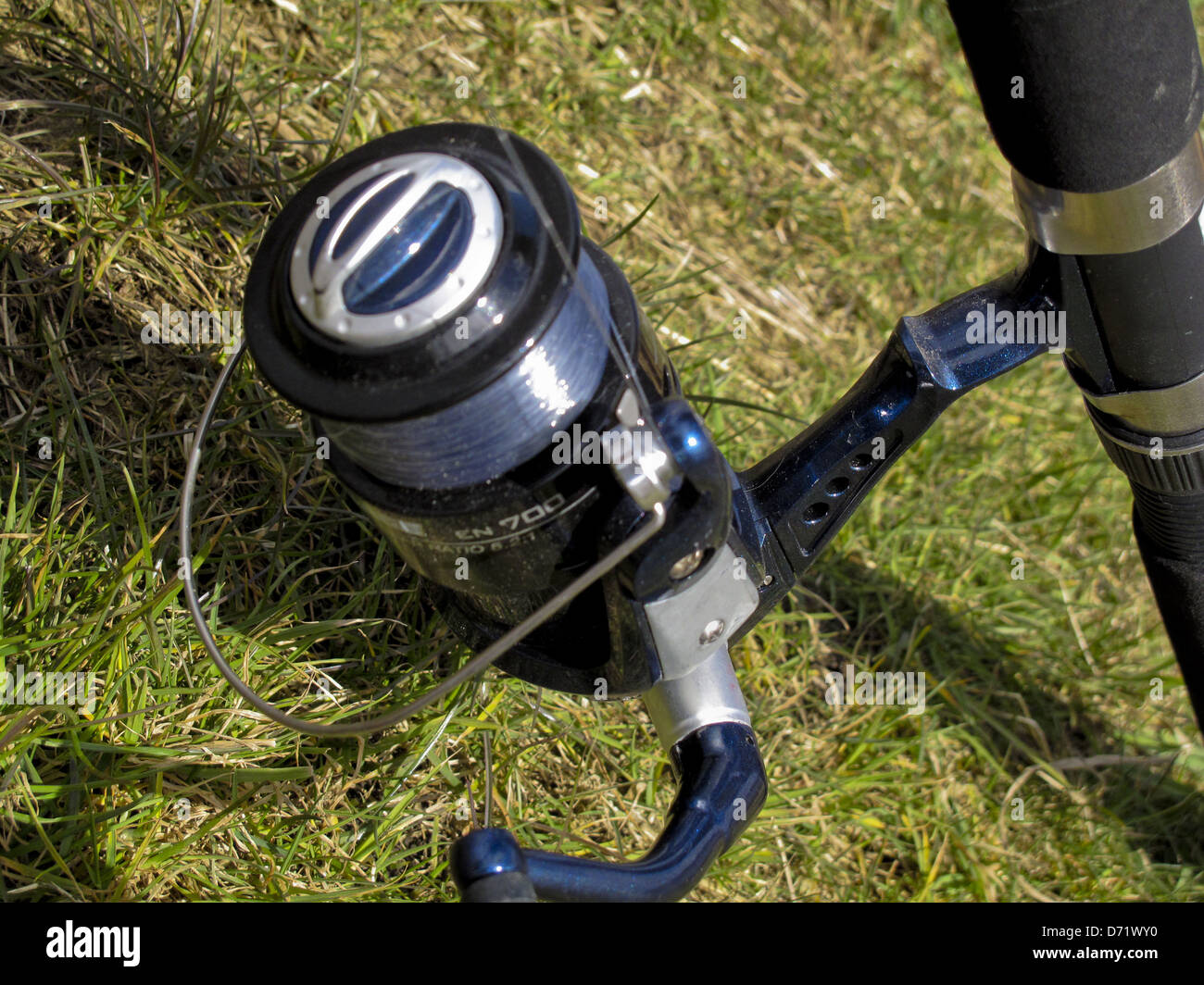 Spinning reel on fishing rod outdoors Stock Photo Alamy