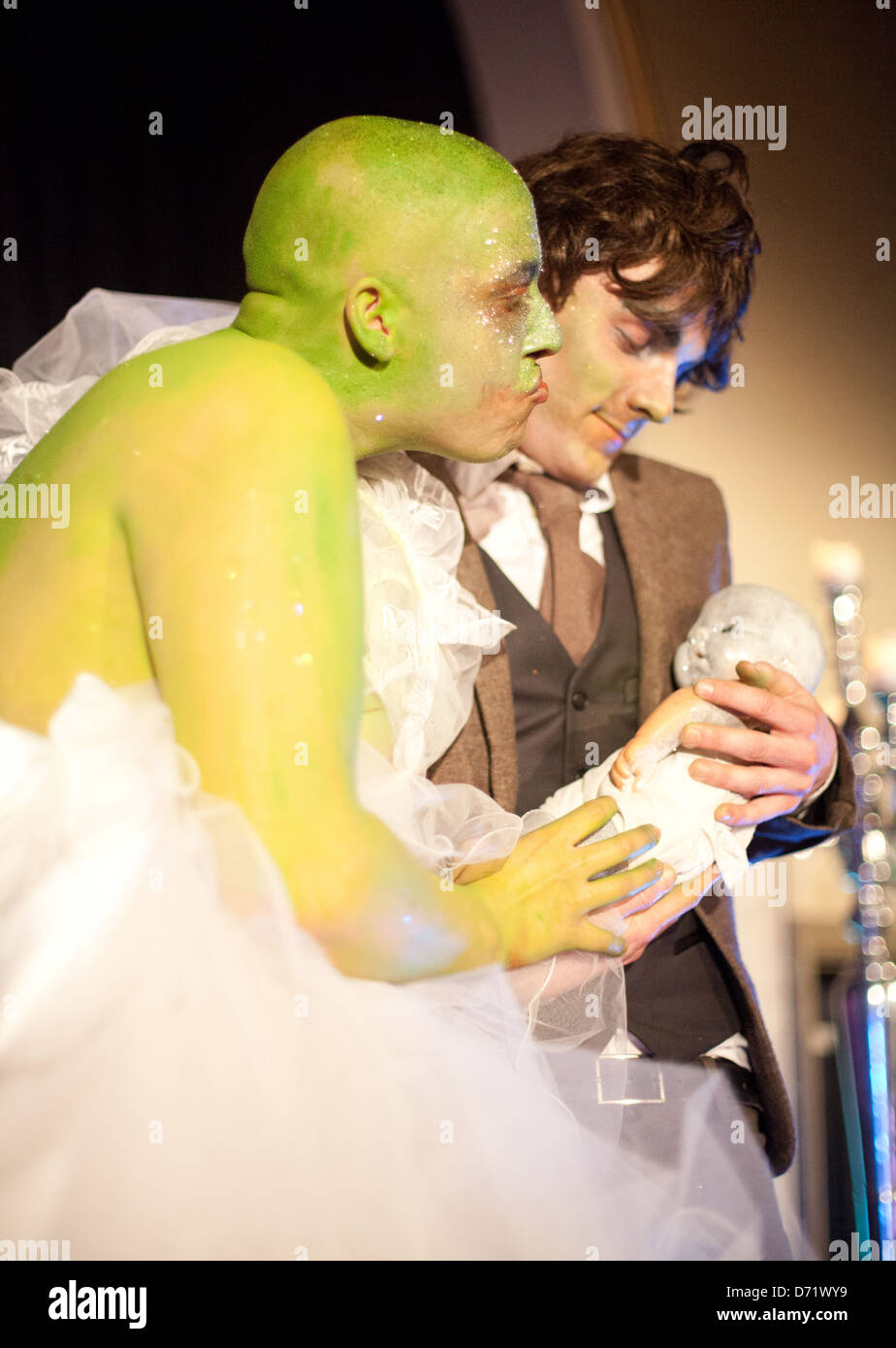 Two actors performing a comedy sketch of a man and a green alien woman at a Dr Sketchy's Burlesque life drawing event Stock Photo