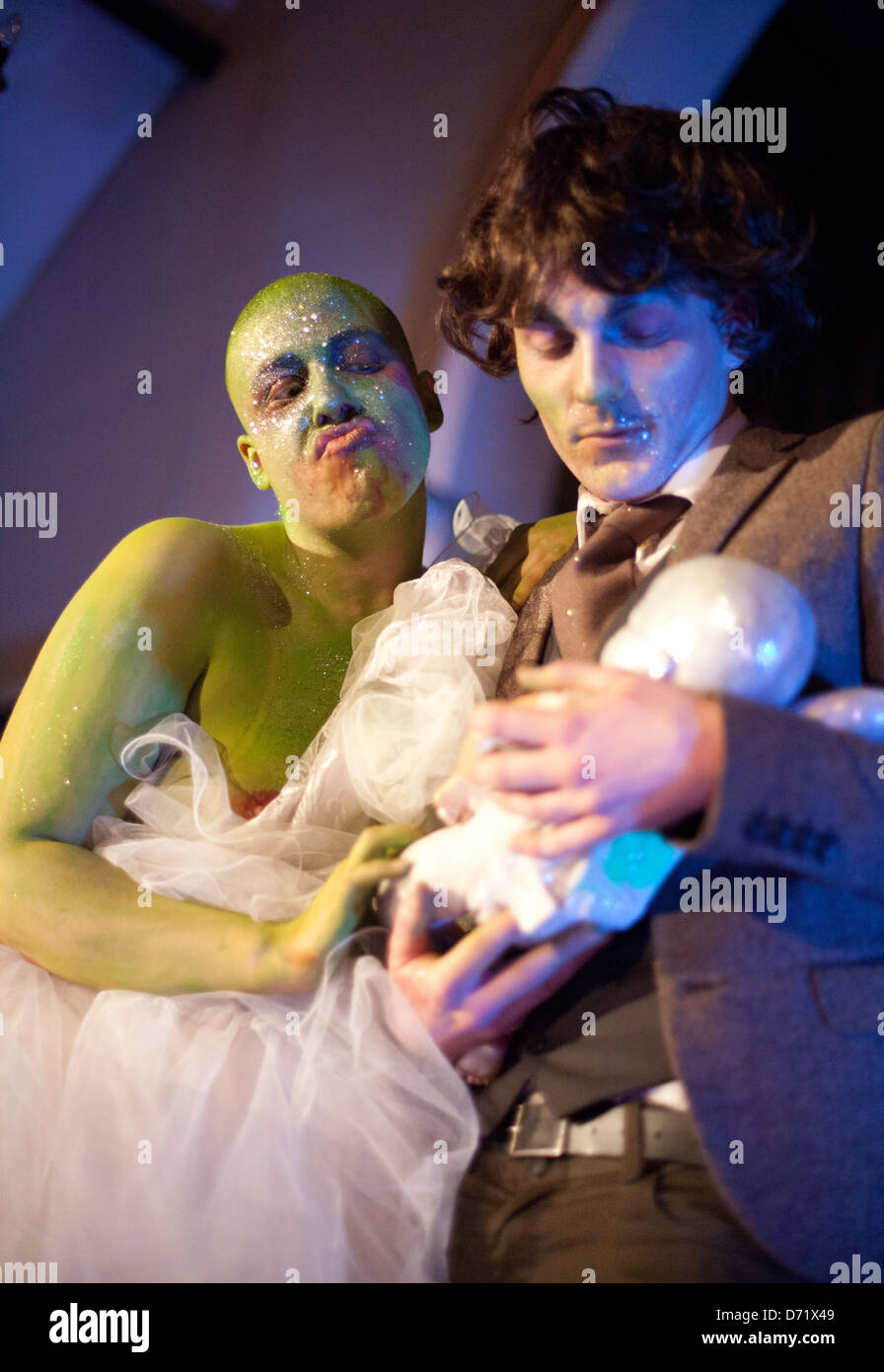 Two actors performing a comedy sketch of a man and a green alien woman at a Dr Sketchy's Burlesque life drawing event Stock Photo