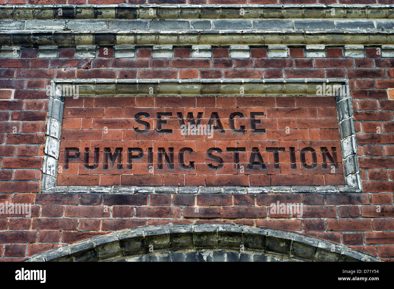 The words Sewage Pumping Station chiseled into brickworks of an old public utility building. Stock Photo