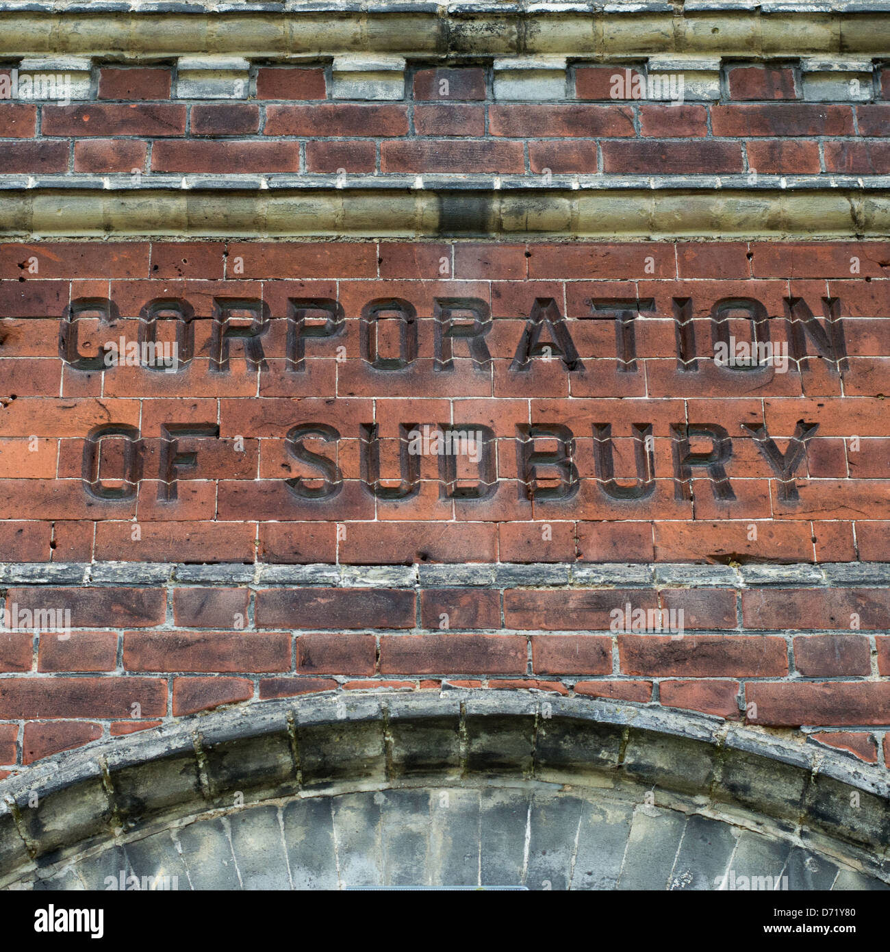 The words Corporation of Sudbury chiseled into brickworks of an old public utility building. Stock Photo