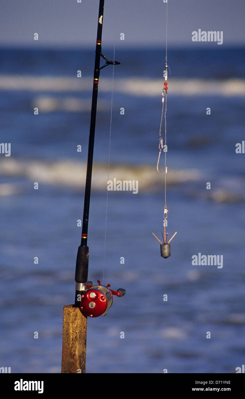A rod and reel in a rod holder used for surf fishing on the beach at  Matagorda Island Texas Stock Photo - Alamy