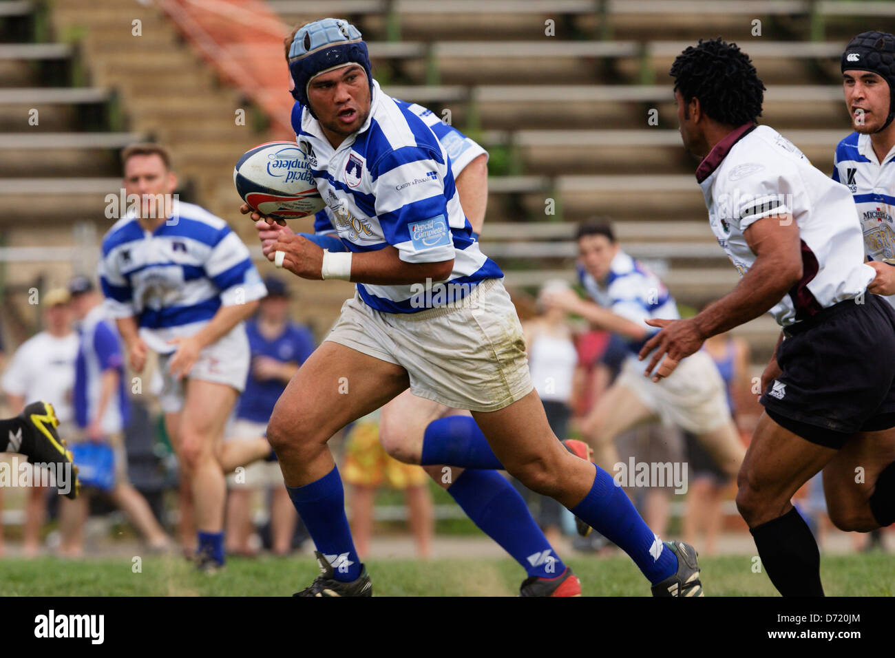 A Washington Rugby Football club player carries the ball during a match at Cardozo High School field. Stock Photo