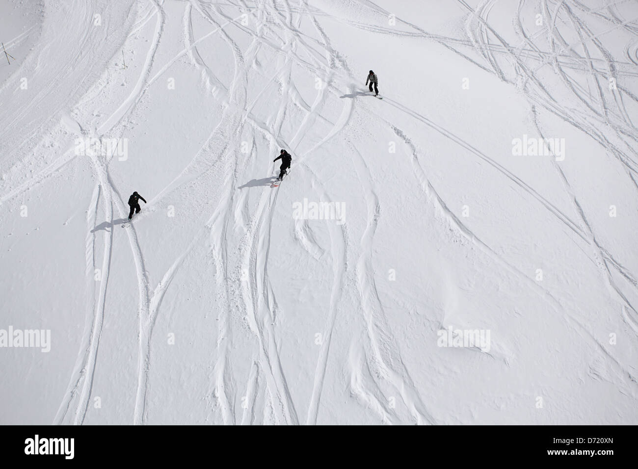 Three snowboarders in action. Typical travel type photo from a skiing holiday in the French Alps Stock Photo