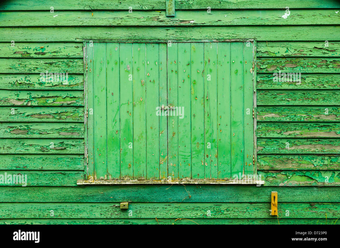 A shuttered window of an old wooden shed with peeling paint Stock Photo ...
