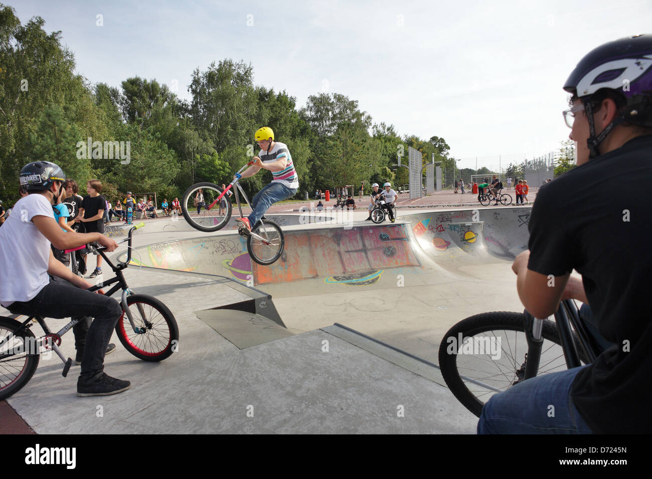 Berlin, Germany, teenagers drive BMX bikes in the park on track