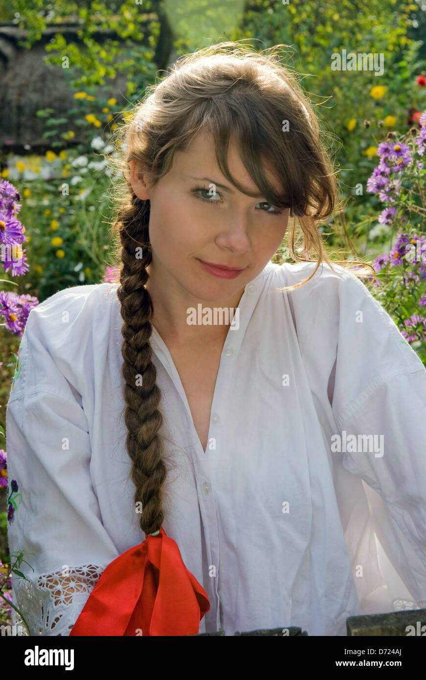Portrait of young woman with long plait, close up Stock Photo