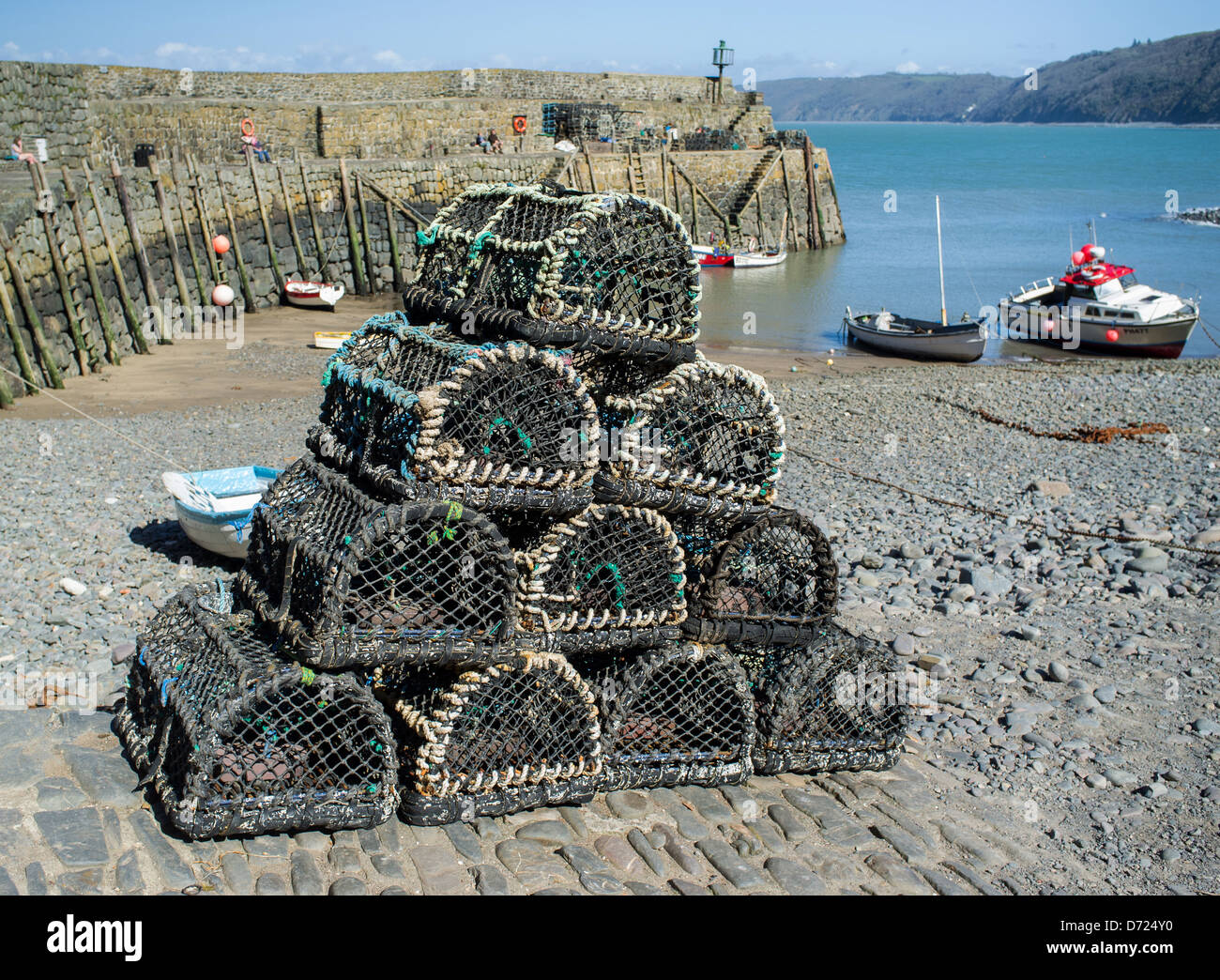 Clovelly, England. Lobster and crap pots at Clovelly Habour, Harbor, with the sea wall and cliffs of the North Devon coastline. Stock Photo