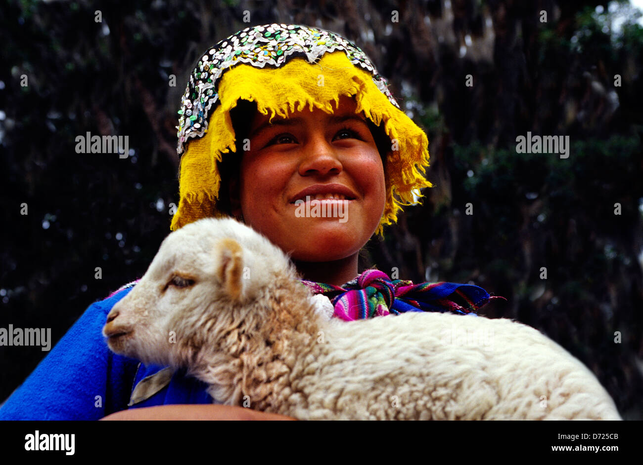 Girl in native dress holding lamb .Pisac.Peru. Stock Photo
