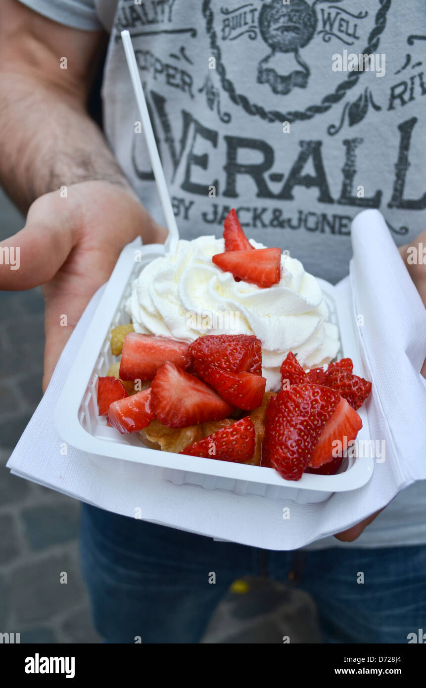 Fresh Belgian waffles topped with strawberries and whipped cream Stock ...