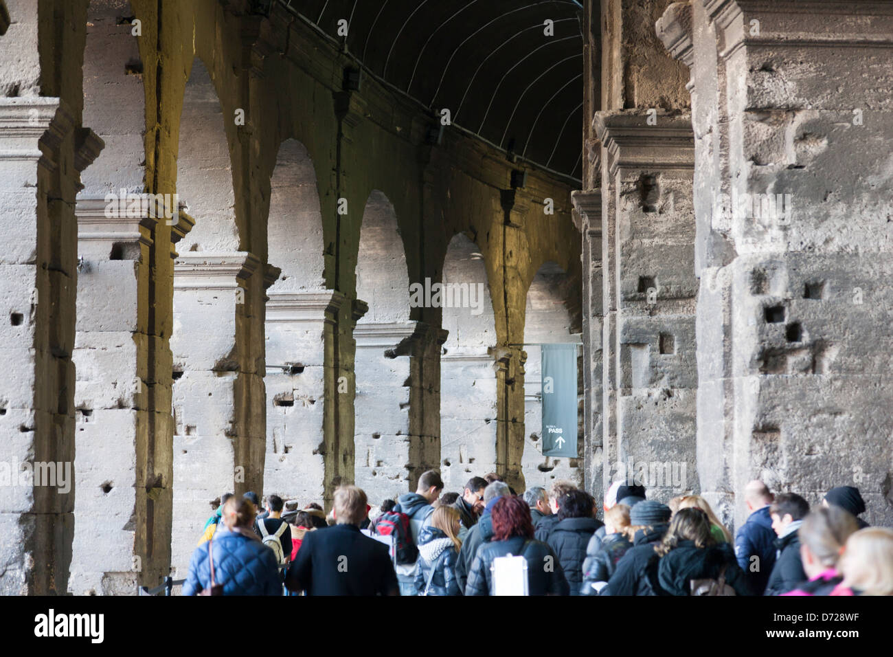 Tourists queue inside the Colosseum or Coliseum, also known as the Flavian Amphitheatre Stock Photo
