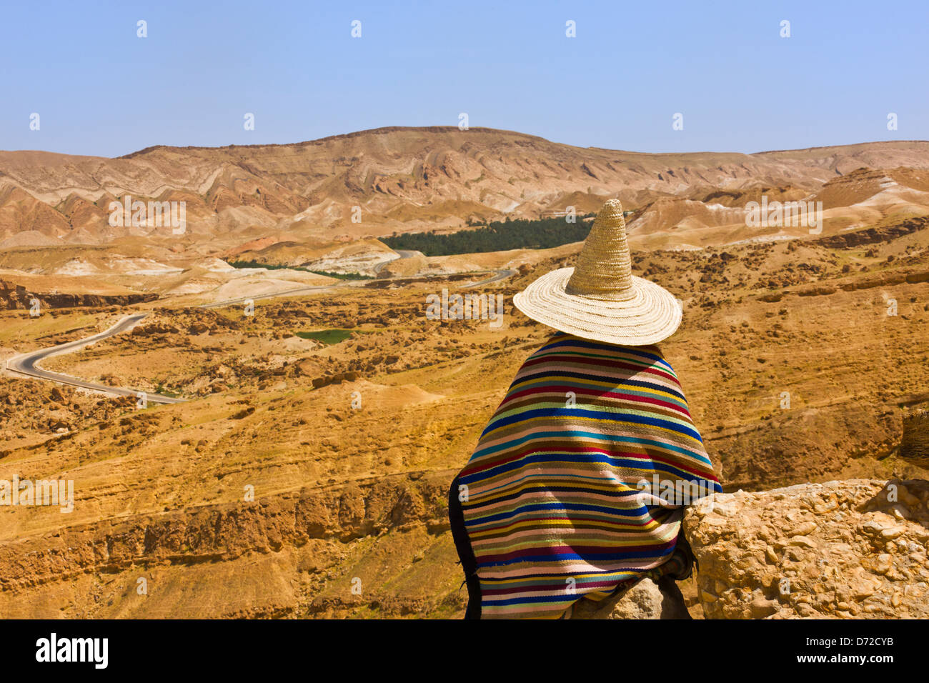 Berber man with Atlas-Sahara Mountain, Tamerza, Tunisia Stock Photo