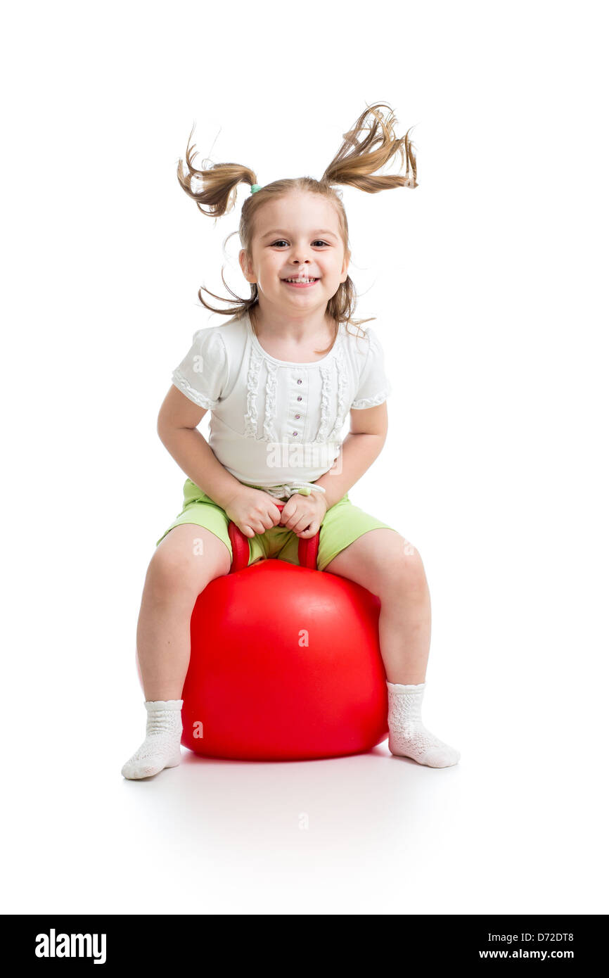 happy child jumping on bouncing ball. Isolated on white Stock