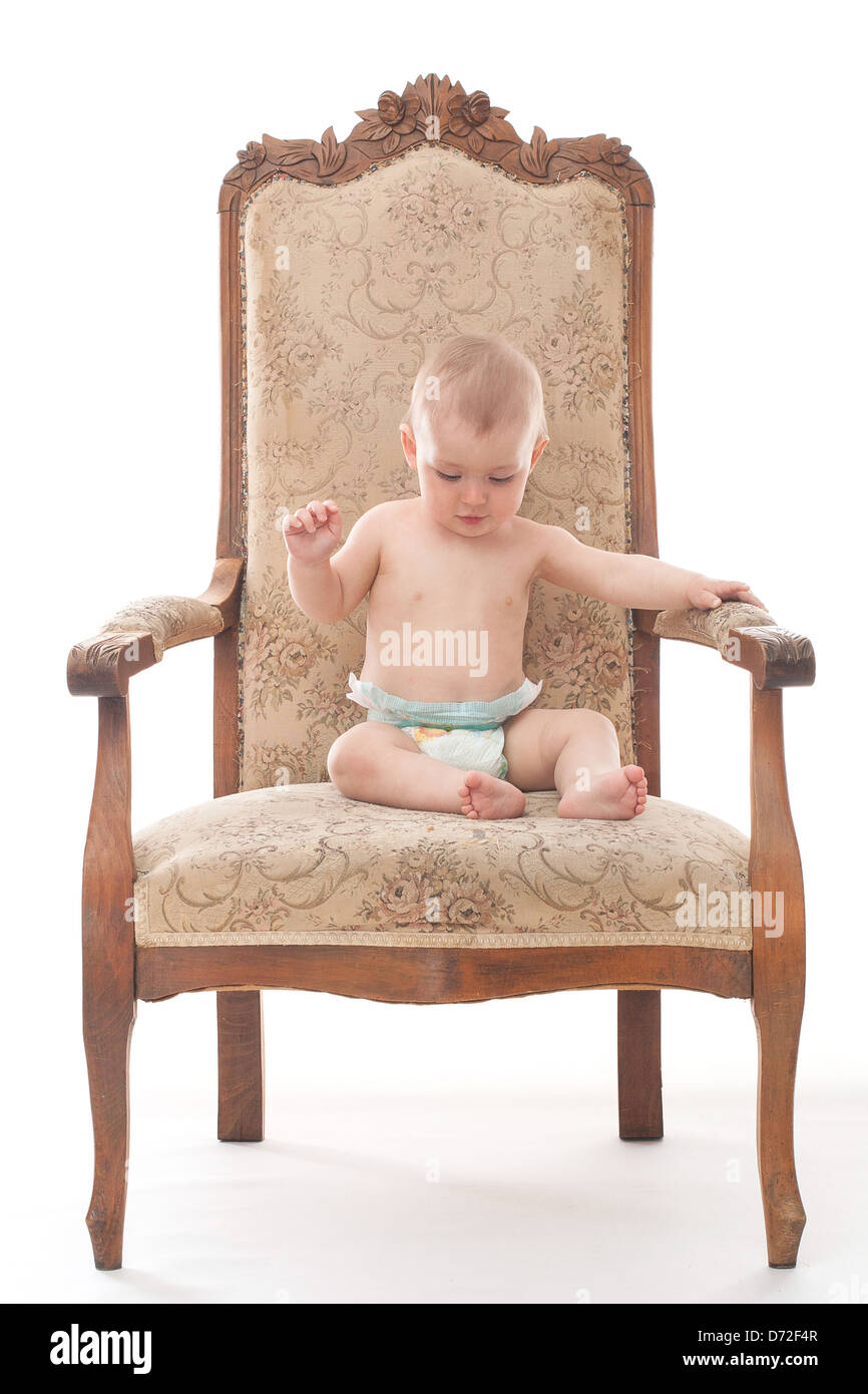 Little boy sits on the retro chair Stock Photo