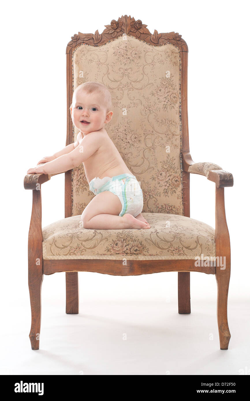 Little boy sits on the retro chair Stock Photo