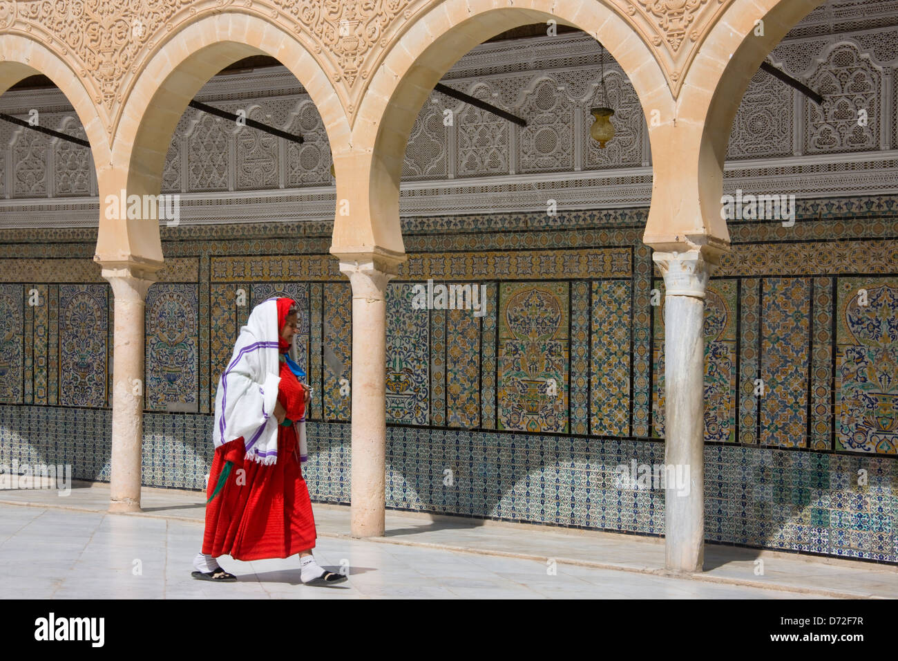 Woman at Mausoleum and Medrasa of Abi Zamaa Alo-Balawi, Kairouan, Tunisia Stock Photo