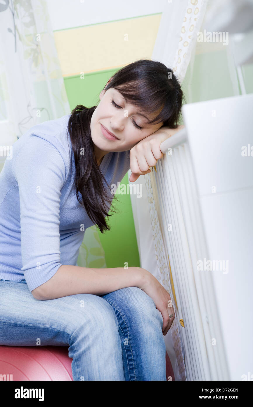 portrait of a young tired woman in the nursery Stock Photo