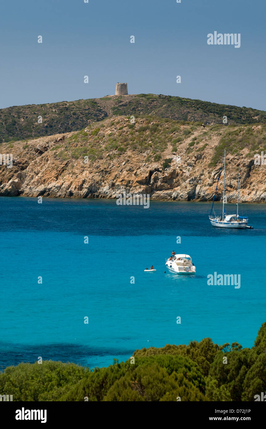 Clear turquoise waters of the sea with yachts at moor on the coast near Tuerredda beach, Teulada, Cagliari, Sardinia, Italy Stock Photo