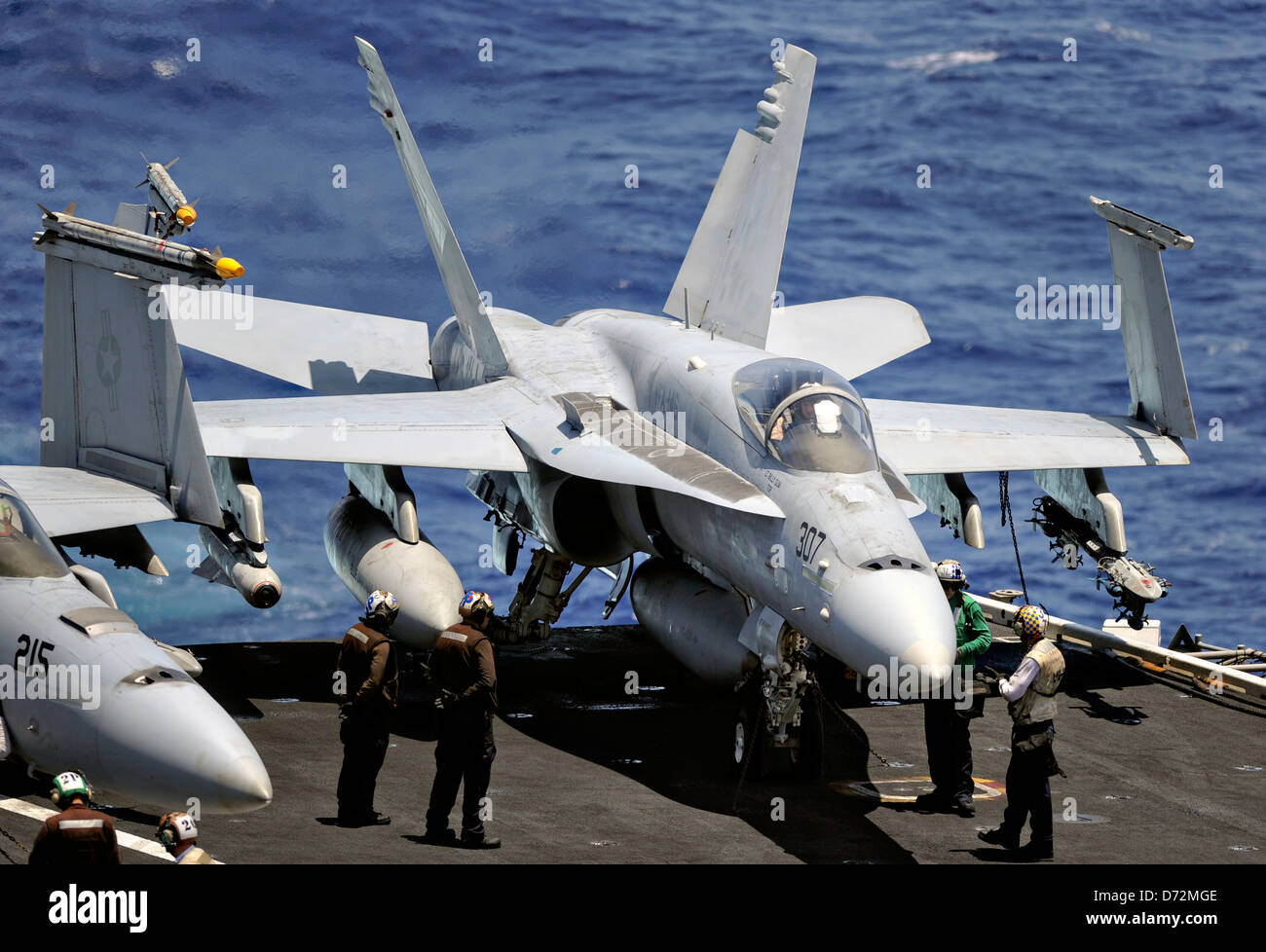A US Navy F/A-18C Hornet fighter aircraft prepares to take off during flight operations on the aircraft carrier USS Nimitz April 25, 2013 in the Pacific Ocean. Stock Photo