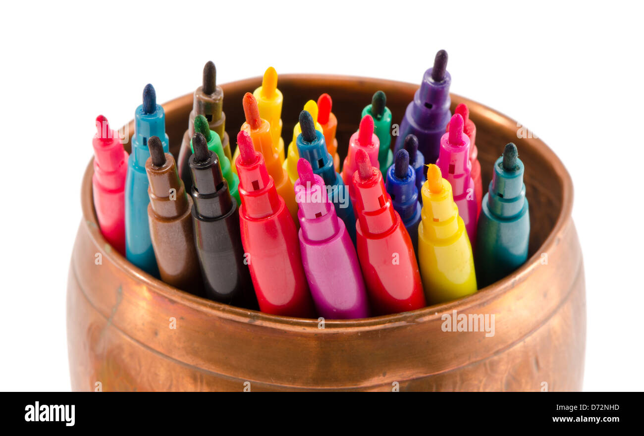 closeup of various color felt-tip pens without caps in copper bowl isolated on white. Stock Photo