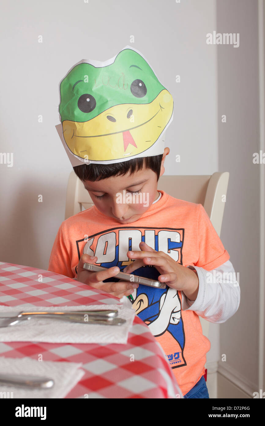 Young boy playing on mobile phone. Stock Photo