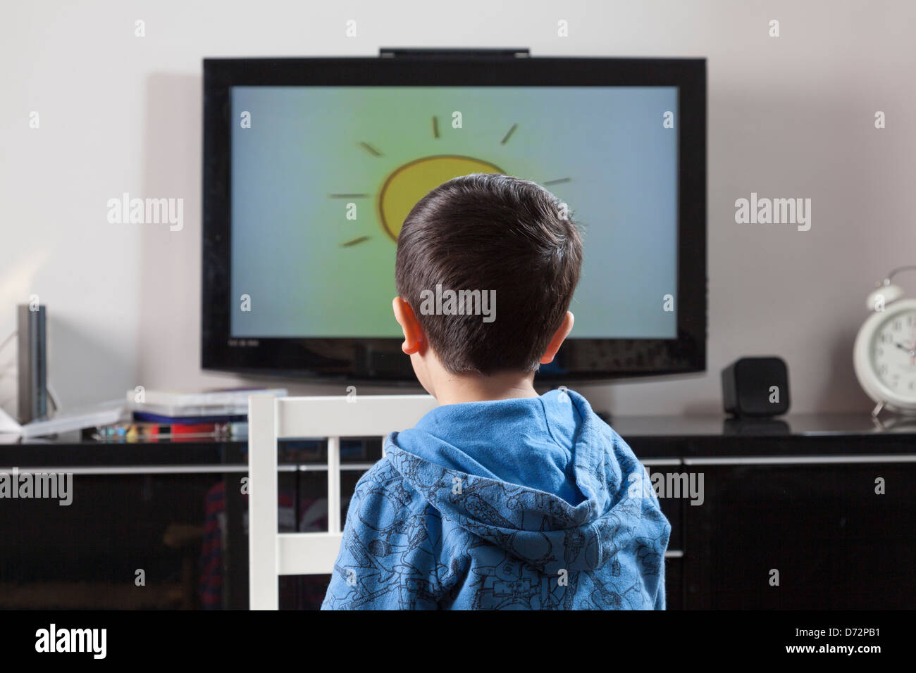 Child watches television-back view Stock Photo