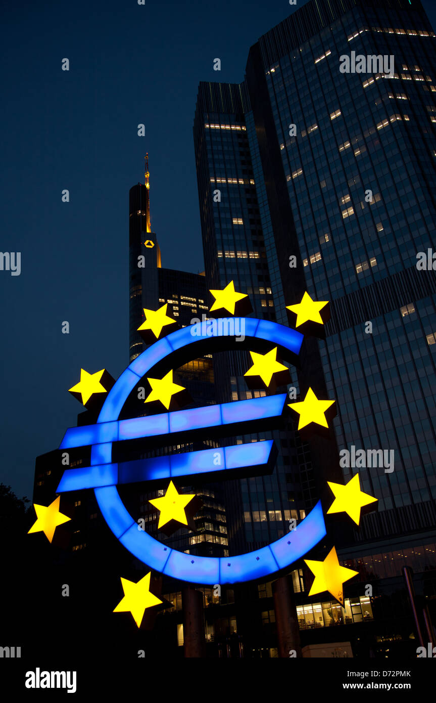 Frankfurt, Germany, the illuminated euro sculpture in front of the Tower of the ECB euro Stock Photo