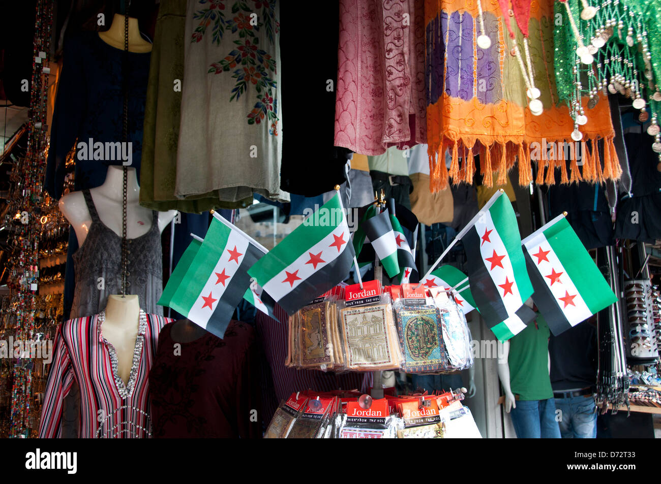 Jordan, Amman. Syrian flags on sale alongside clothing Stock Photo