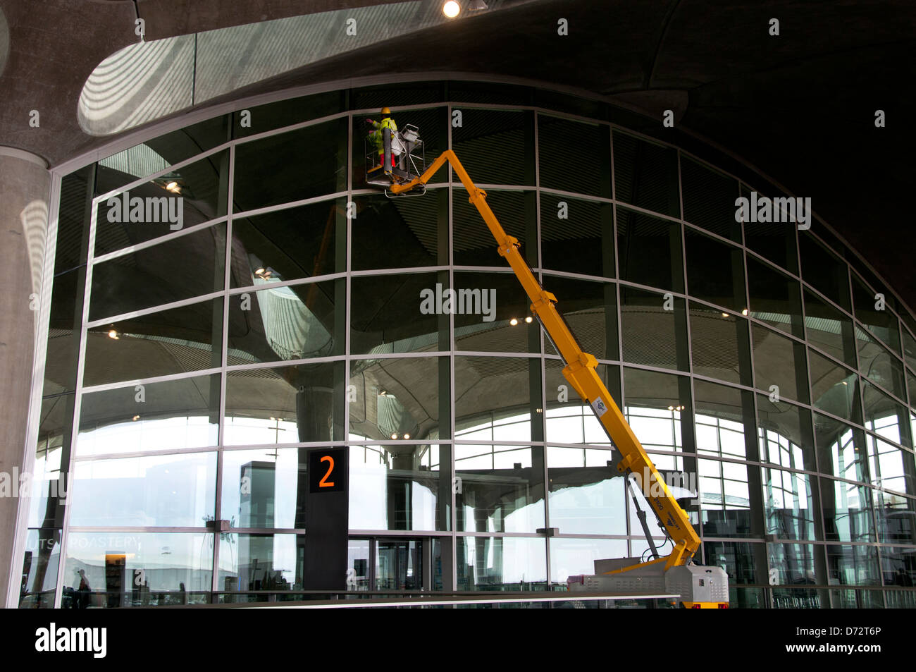 Jordan, Amman. Queen Alia International airport. Airport workers clean terminal windows. Stock Photo