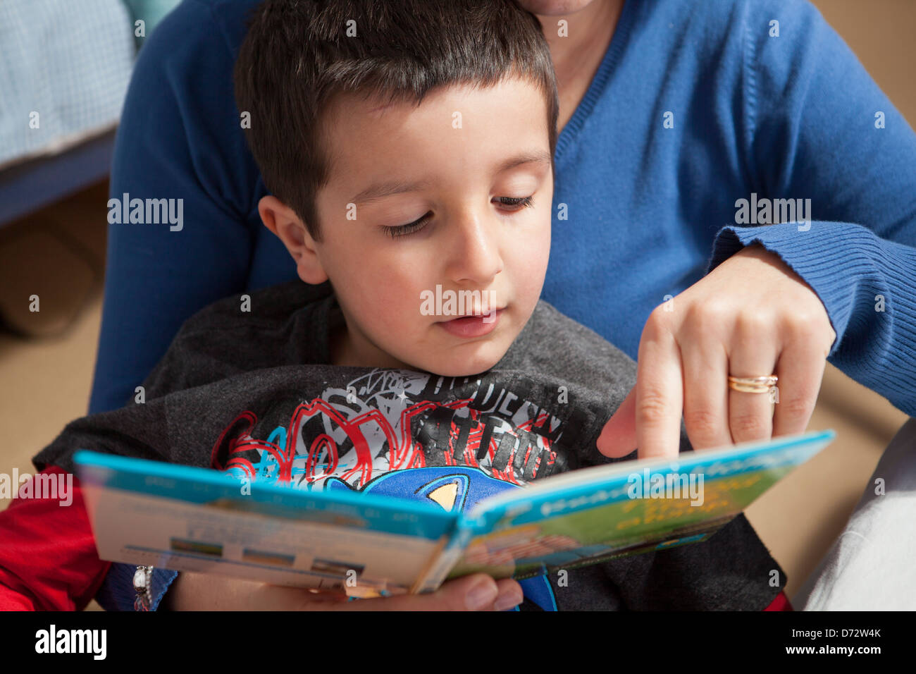 Mother teaches child to read Stock Photo