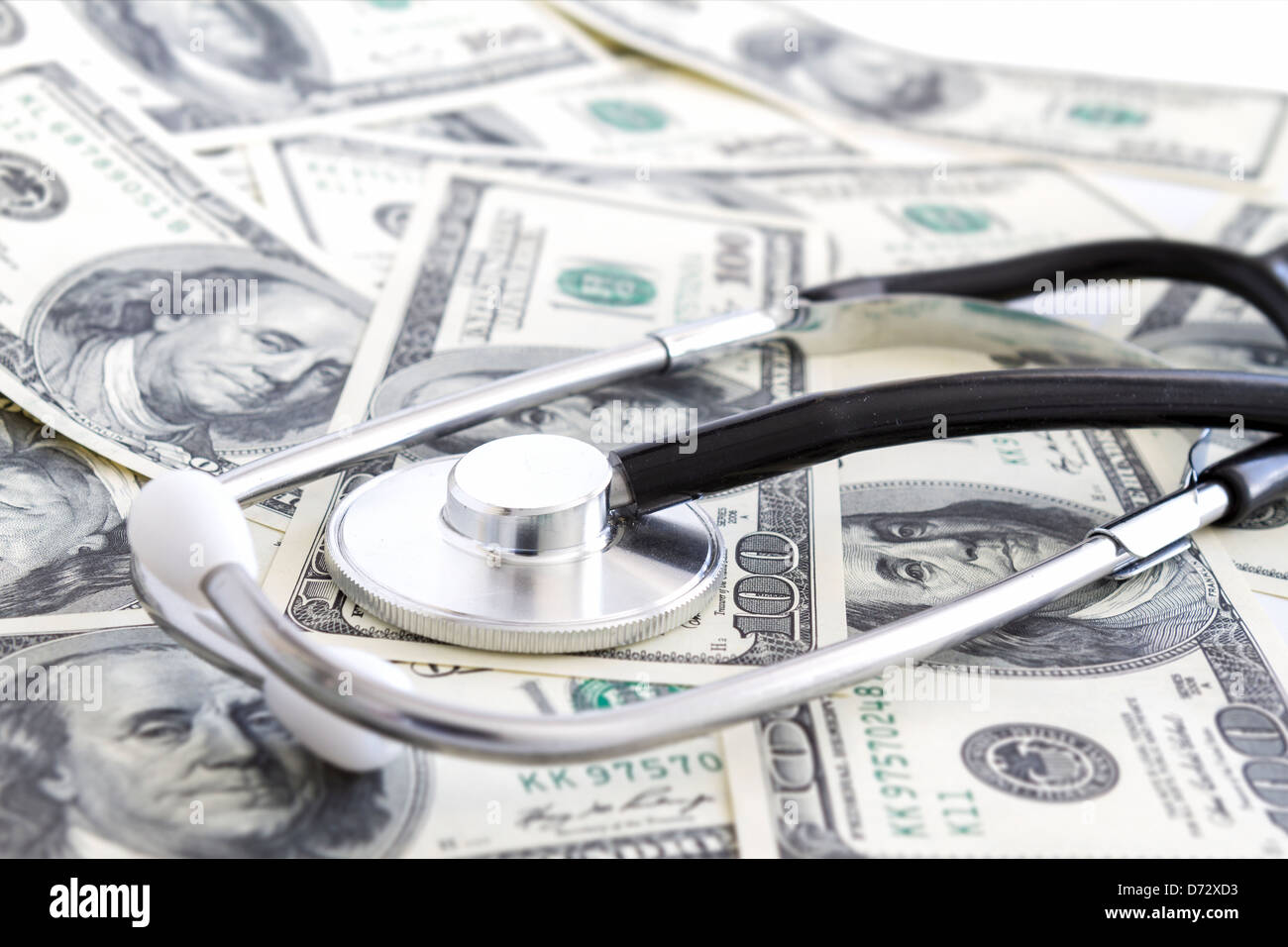 Dollars with stethoscope on them. Costs for the medical insurance. Stock Photo