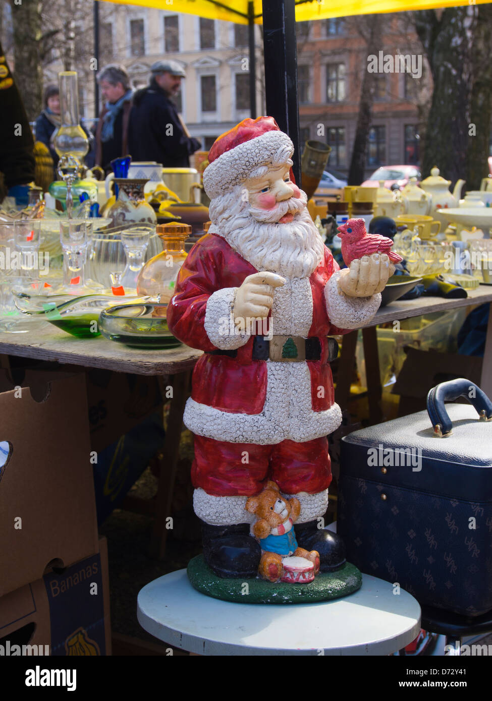 Large Father Christmas figurine dominating a stall in a flea market in