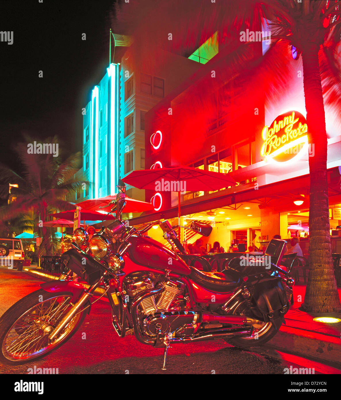 Harley Davidson motorbike in front of Art Deco Hotels at night on Ocean Drive, Miami, Florida