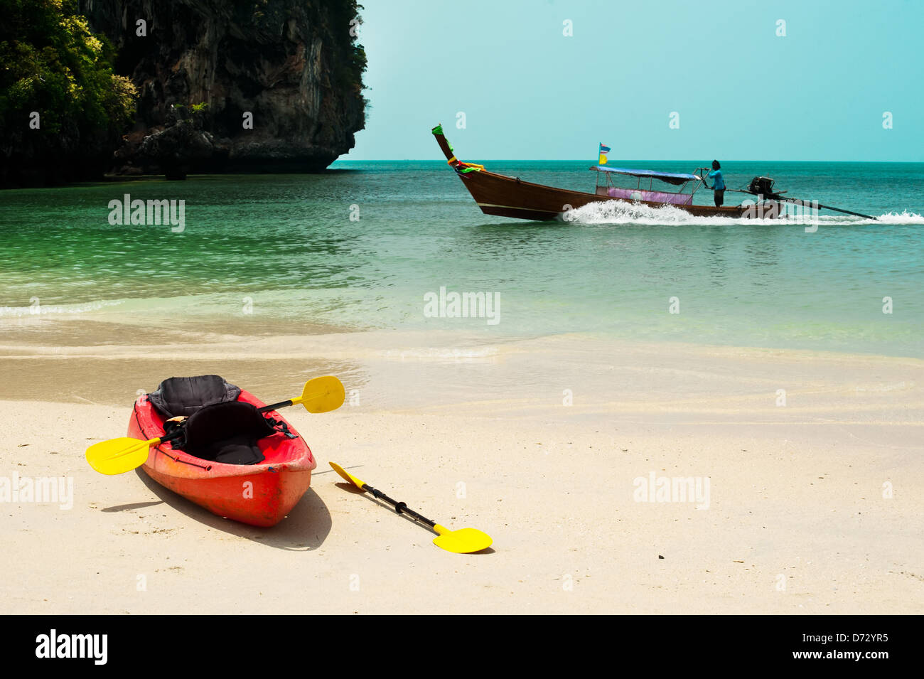 Tropical beach landscape with red canoe boat at ocean gulf under blue