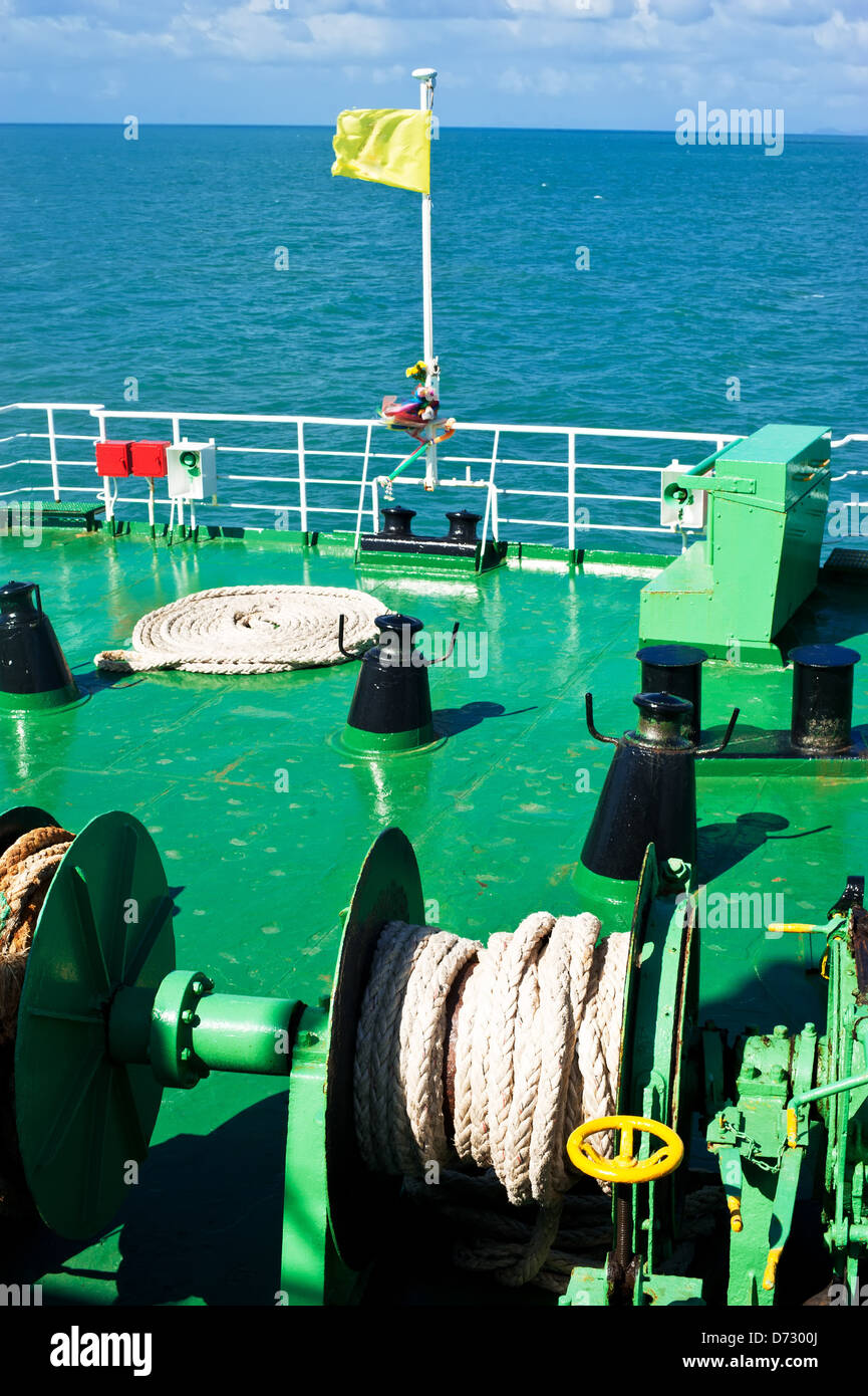 Traveling by sea on ferry boat. Blue sea landscape with sky. View from ship deck with ropes and flag Stock Photo