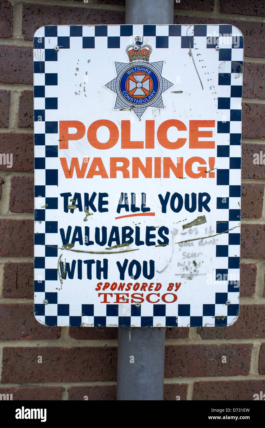 Car Theft Warning Sign at Tesco Supermarket Car Park Stock Photo