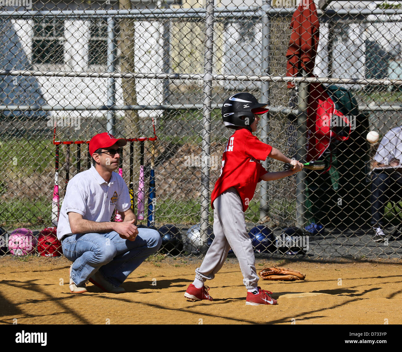Swinging at a baseball. Little league tee ball tball Stock Photo Alamy
