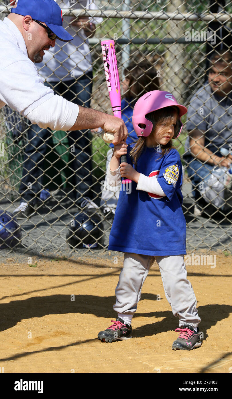 A little girl baseball tee ball tball player getting batting