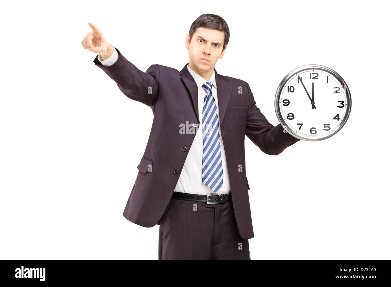 Angry businessman holding a clock and pointing with a finger, isolated on white background Stock Photo