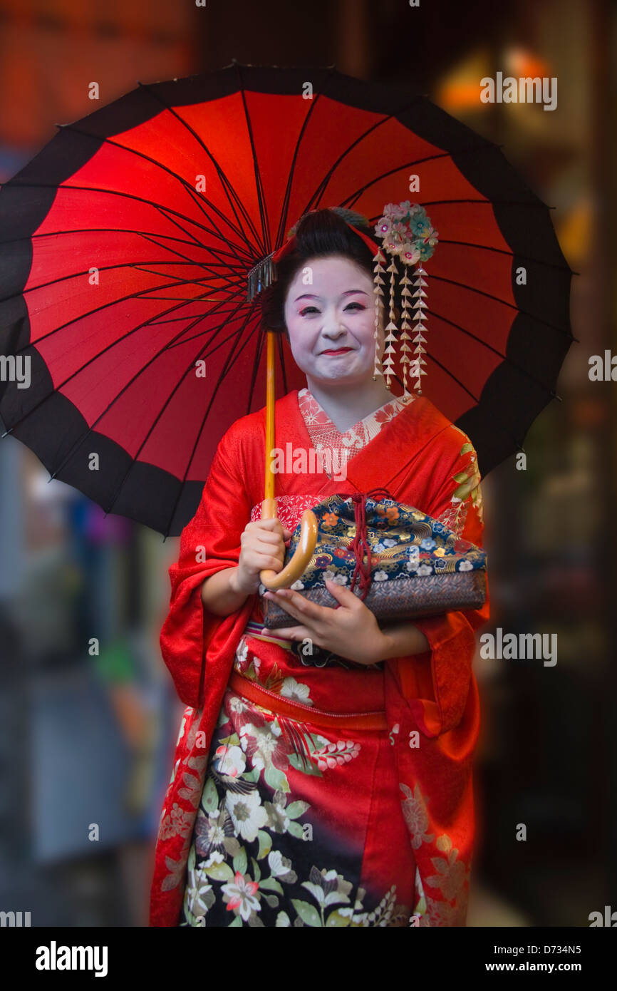 Geisha in kimono with red umbrella, Asakusa, Tokyo, Japan Stock Photo