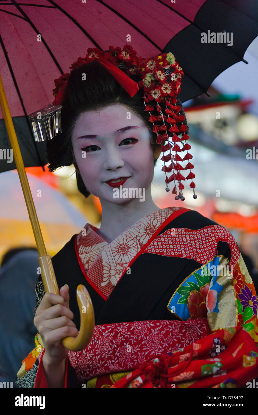 Geisha in kimono with umbrella walking on the street in rain, Asakusa