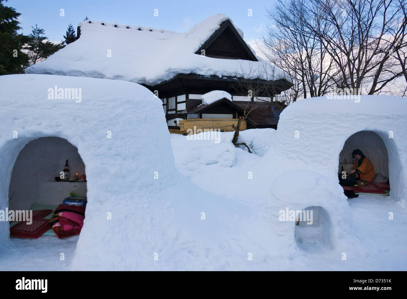 Traditional house covered with snow and igloolike snow house, Yokote